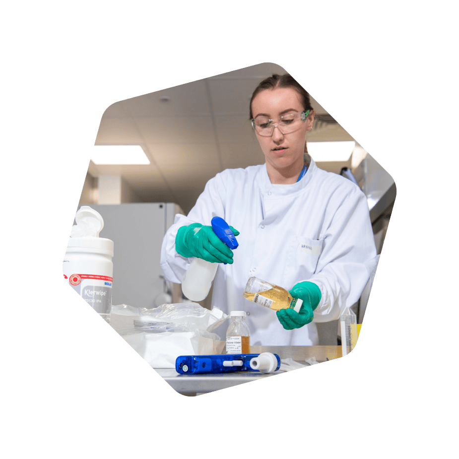 Scientist disinfecting a bottle in lab